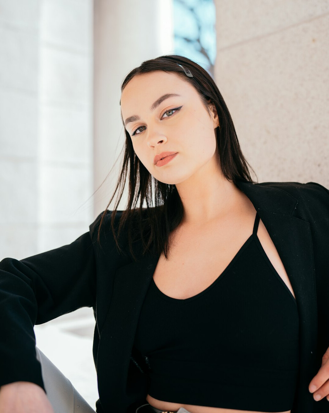 Portrait of a smiling woman with dark hair in a blazer