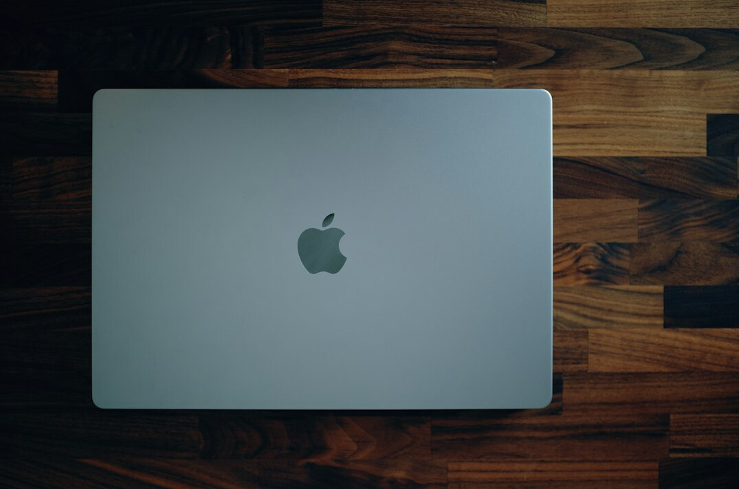 Laptop with programming code on screen on a dark desk