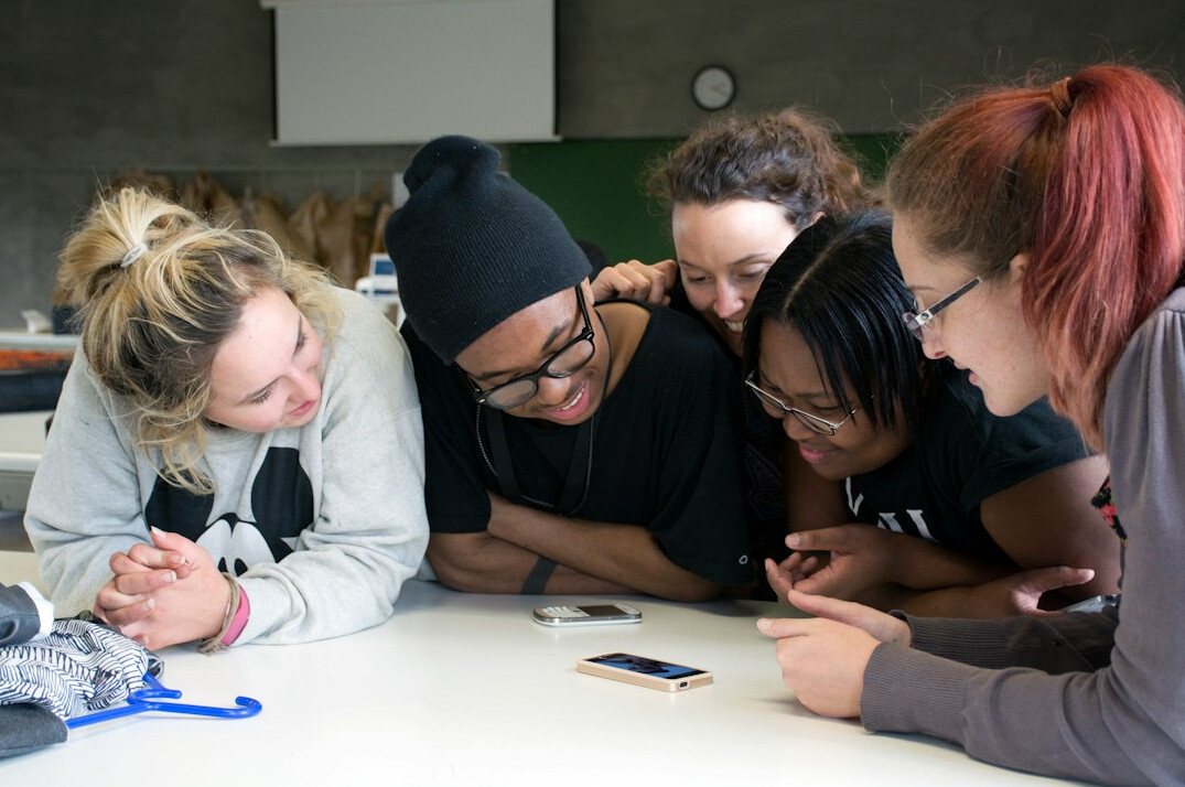diverse students coding together