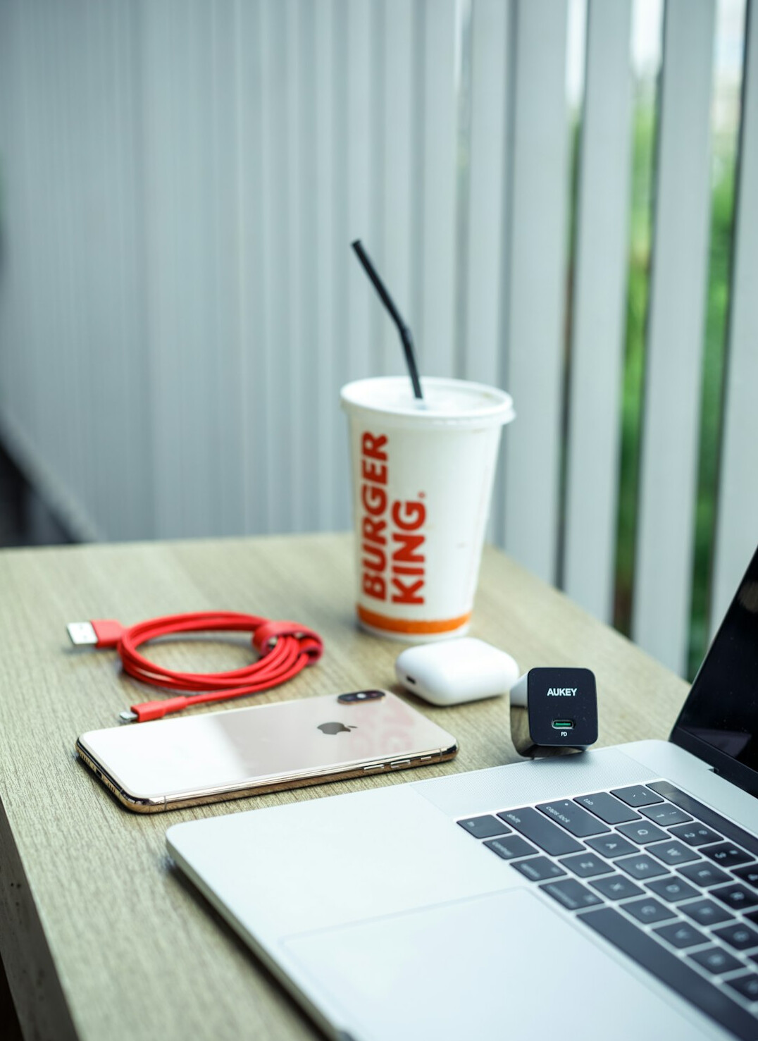 Desk with laptop, notebook and coffee cup