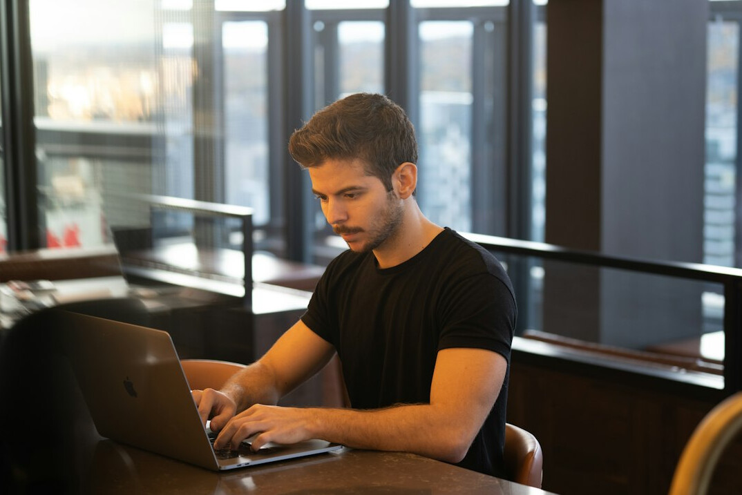 person working remotely on laptop