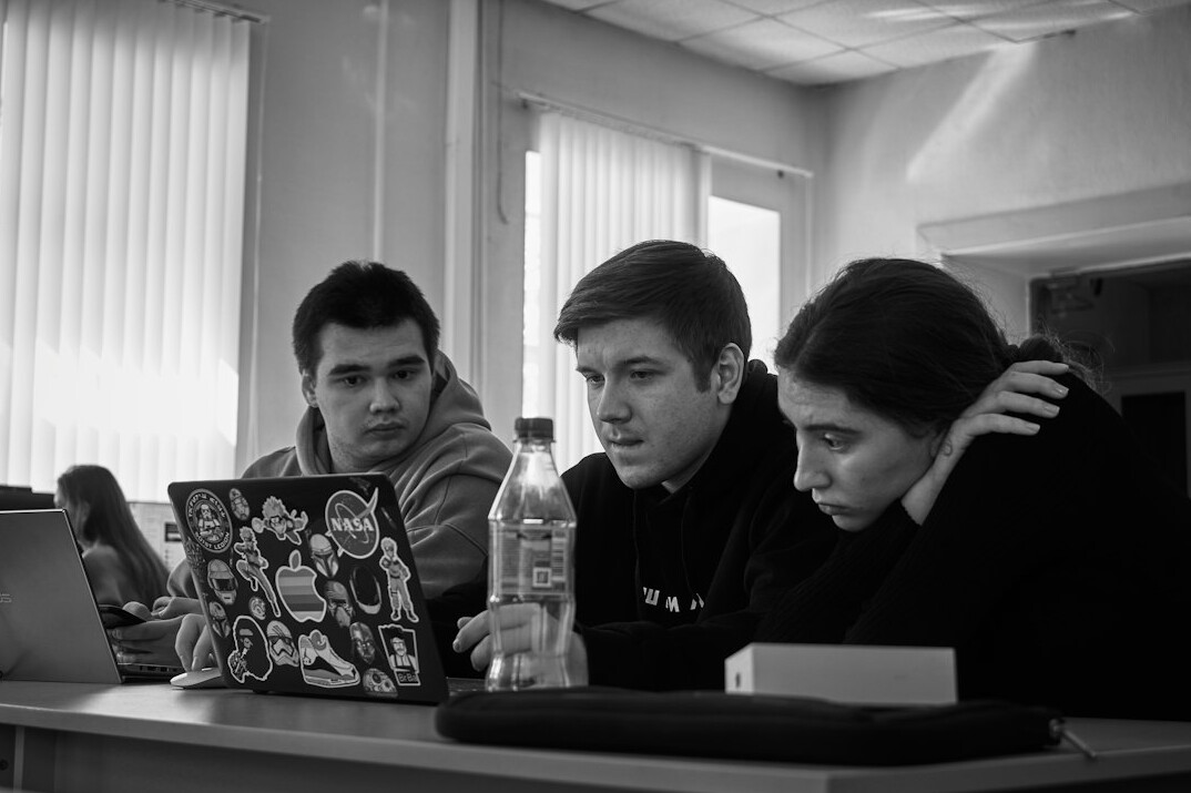 group of students coding together